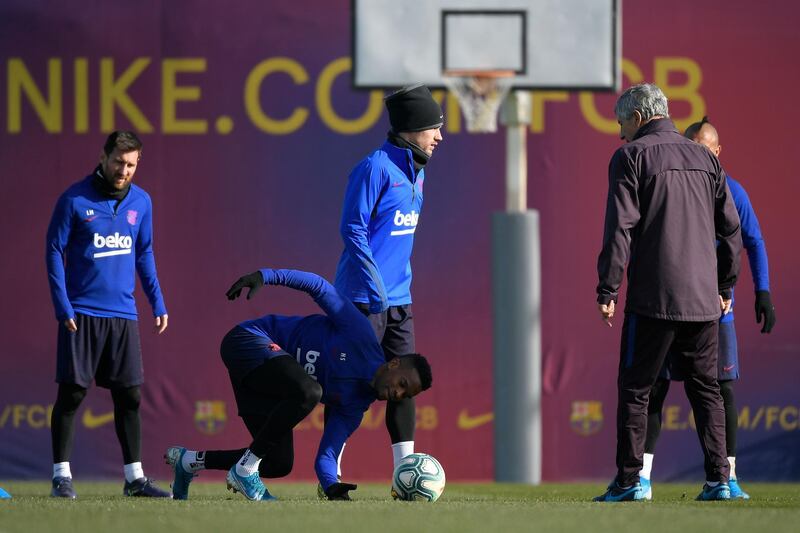 Barcelona manager Quique Setien with Lionel Messi Antoine Griezmann, and Samuel Umtiti during a training session at the Joan Gamper Sports City. AFP