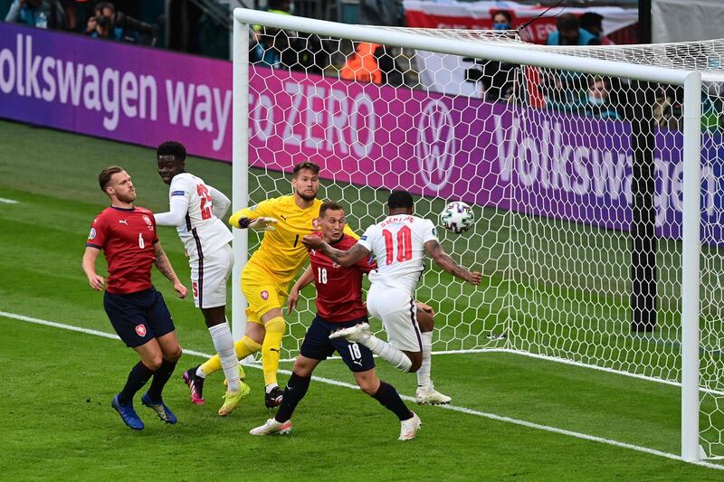 England's forward Raheem Sterling (R) scores the opening goal during the UEFA EURO 2020 Group D football match between Czech Republic and England at Wembley Stadium in London on June 22, 2021. / AFP / POOL / NEIL HALL
