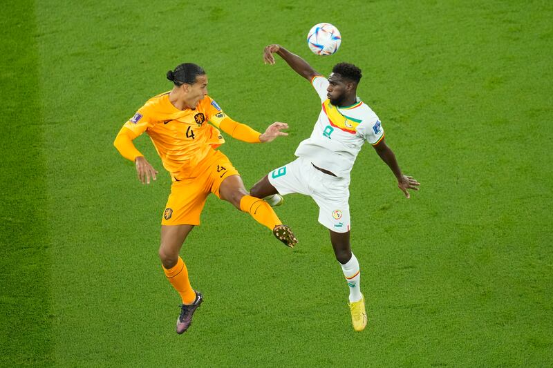 Virgil van Dijk of the Netherlands, left, vies for the ball with Senegal's Boulaye Dia. AP 