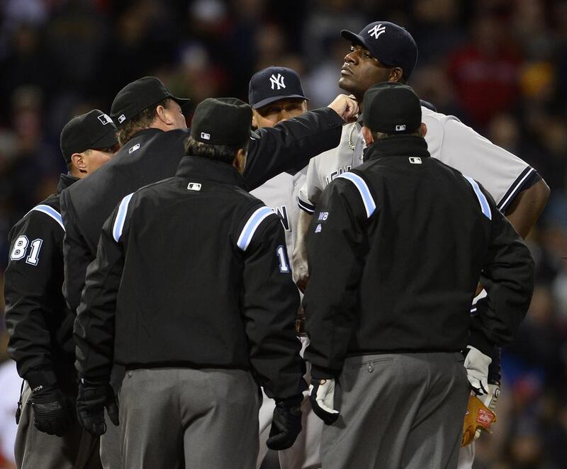 New York Yankees starting pitcher Michael Pineda, second from the right, is inspected by home plate umpire Gerry Davis, second from left, during the second inning against the Boston Red Sox at Fenway Park in Boston, Massachusetts, on April 23, 2014. Pineda was ejected from the game for pine tar. CJ Gunther / EPA