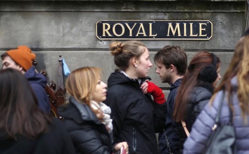 Pedestrians walk along the Royal Mile, a busy street which runs from Edinburgh Castle to Holyrood Palace, in Edinburgh. Suzanne Plunkett / Reuters