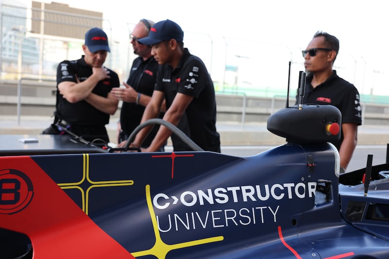 A pit crew fine tuning their car at Yas Marina Circuit.