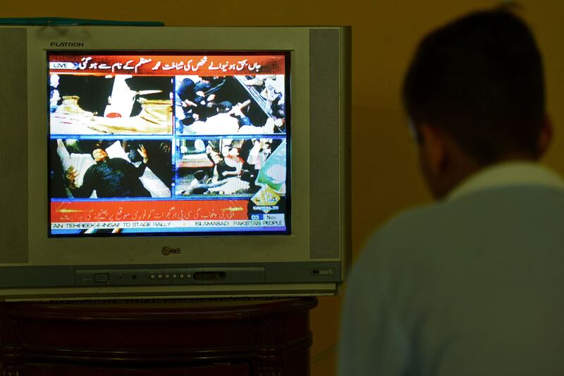 A boy in Islamabad watches television showing news of the shooting. AFP