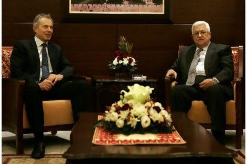 The former British prime minister and international mideast envoy Tony Blair, left, meets Mahmoud Abbas, the Palestinian president, in the West Bank city of Ramallah on Monday.