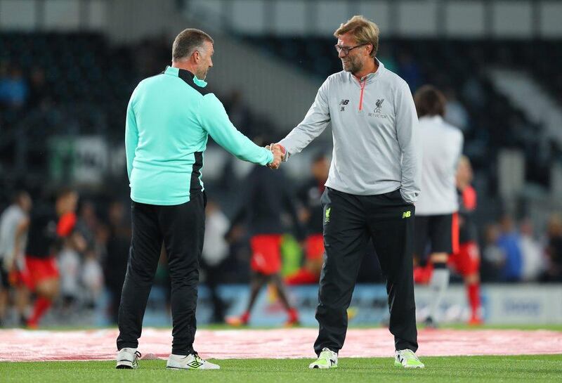 Derby County manager Nigel Pearson, left, shakes hands with Liverpool manager Jurgen Klopp. Richard Heathcote / Getty Images