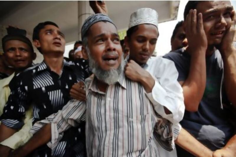 Thousands of Muslims attended the funerals at Yaeway cemetery in Yangon for the 13 boys killed in a mosque fire.