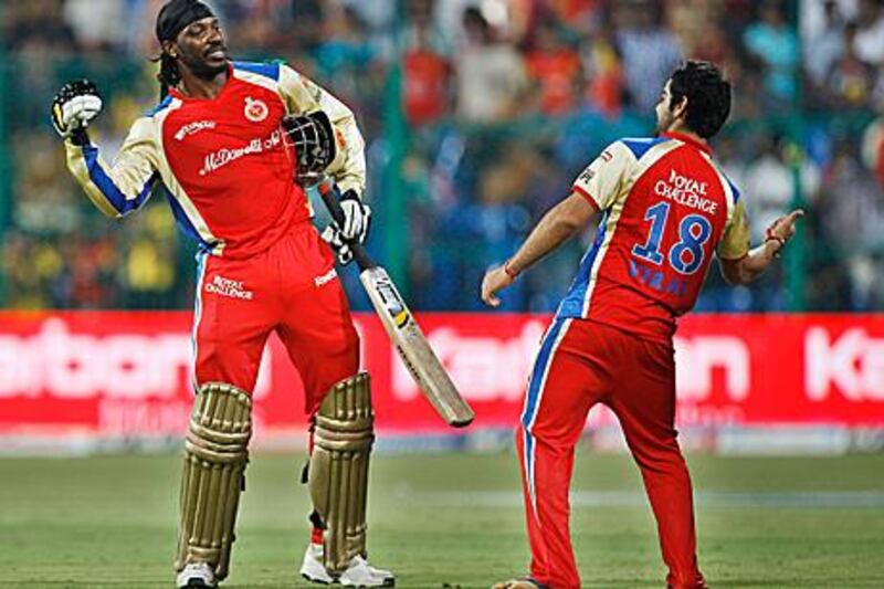 Chris Gayle, left, and Virat Kohli celebrate beating Chennai by eight wickets in their final IPL league match.