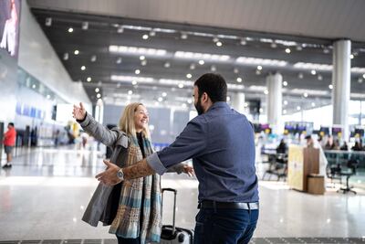 The emotional airport reunion may become less common under UK plans to make gaining a spousal visa more difficult. Getty Images
