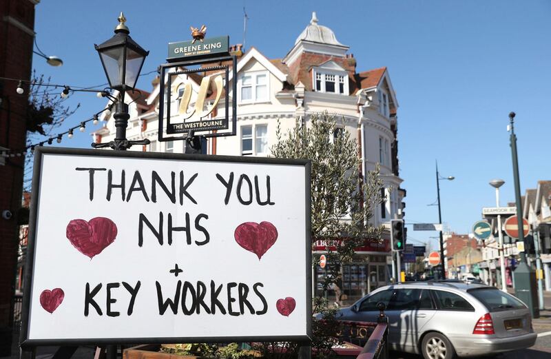 A sign thanking NHS staff and key workers is displayed outside The Westbourne pub in Bournemouth, south England as the UK continues in lockdown to help curb the spread of the coronavirus Wednesday April 1, 2020. The highly contagious COVID-19 coronavirus has impacted on nations around the globe, many imposing self isolation and exercising social distancing when people move from their homes. (Andrew Matthews/PA via AP)