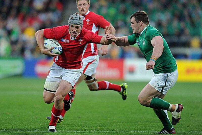 Jonathan Davies, the Welsh centre, fends off Ciaran Healy, the Ireland prop, before crossing over the line to score a try.

Dave Hunt / EPA
