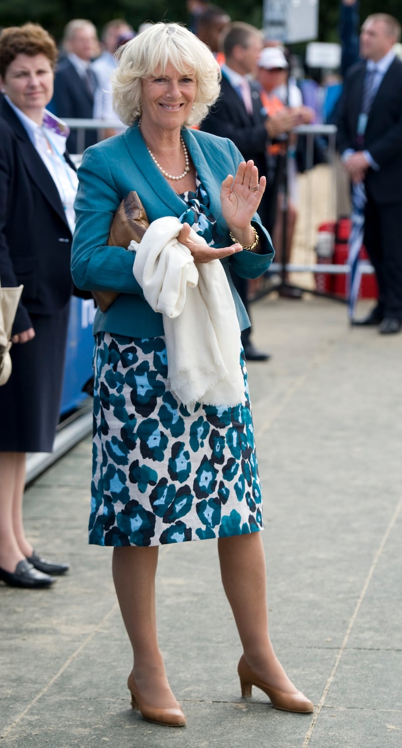 The queen consort attends the London 2012 Olympics Equestrian Eventing at Greenwich Park wearing a blue animal print dress on July 6, 2011. Getty Images