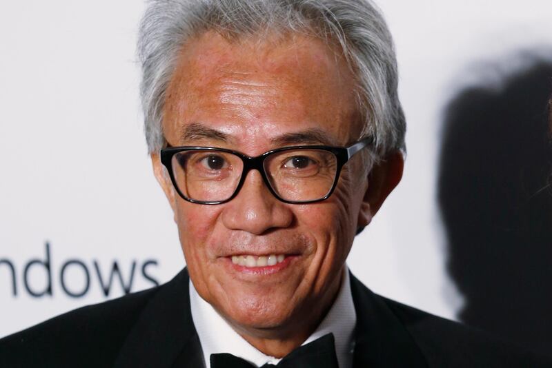 In this Saturday, March 14, 2015, photo, Hong Kong businessman and socialite David Tang, poses on the red carpet for the fundraising gala organized by amfAR (The Foundation for AIDS Research) in Hong Kong. Tang, a flamboyant and outspoken socialite and entrepreneur who founded the Shanghai Tang fashion brand, has died. He was 63. (AP Photo/Kin Cheung)