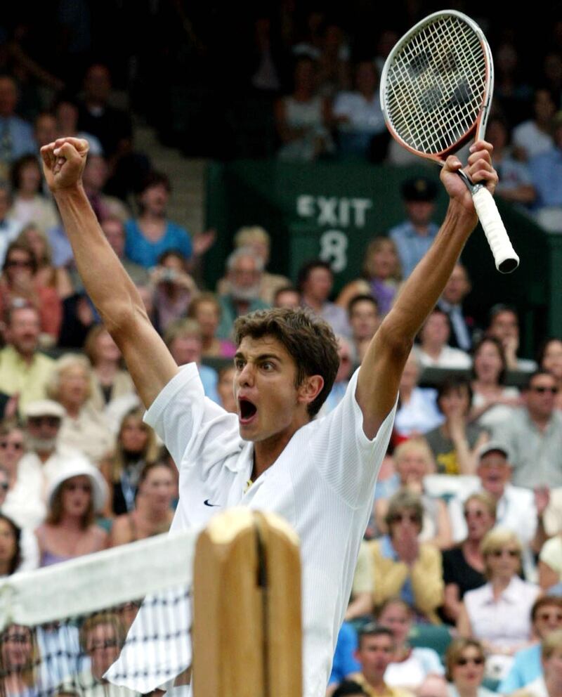 Croatian player Mario Ancic celebrates after his first round match against Swiss Roger Federer at the Wimbledon Tennis Championships, 25 June 2002. Unheralded Ancic defeated 7th seeded Federer in straight sets 6-3, 7-6 and 6-3. (Photo by GERRY PENNY / AFP)