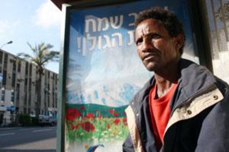 An Eritrean refugee at a bus stop in Tel Aviv. Many migrants and refugees live in the Tel Aviv area near the central bus station.