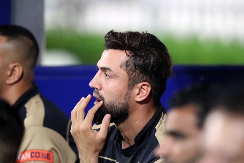 Future Mattress player Rohan Mustafa watches the Sharjah Ramadan Cup final from the dugout.