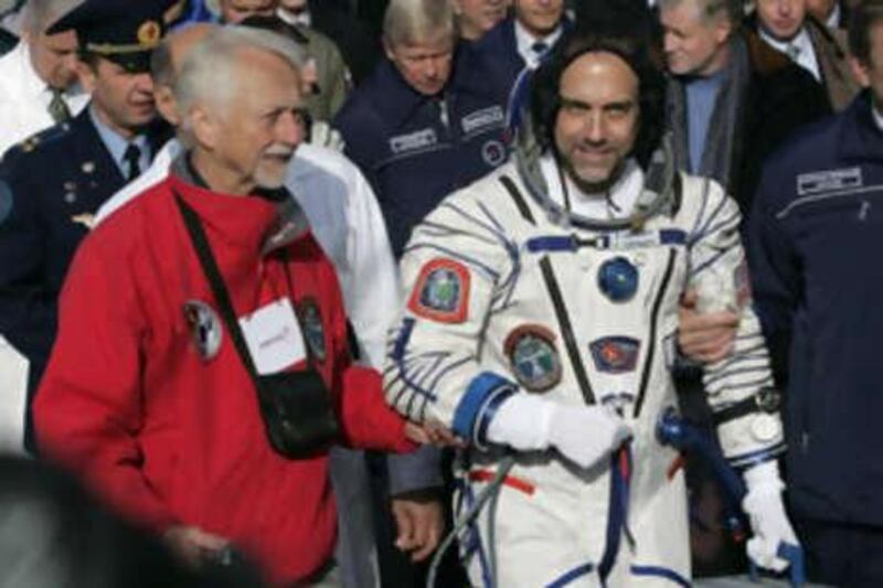 U.S. astronaut Owen Garriott, left, accompanies his son U.S. space tourist Richard Garriott, crew member of the 18th mission to the International Space Station (ISS), to the Soyuz-FG rocket prior to the launch at the Russian leased Baikonur Cosmodrome, Kazakhstan, Sunday, Oct. 12, 2008. (AP Photo/Dmitry Lovetsky) *** Local Caption ***  BAIK102_Kazakhstan_Russia_Space.jpg