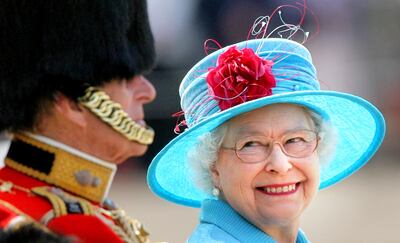 Queen Elizabeth II smiling with the Duke of Edinburgh during the annual Trooping the Colour ceremony in 2009. PA