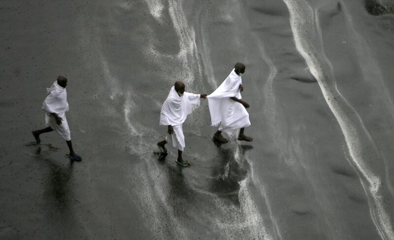 Hajj pilgrims seek shelter during heavy rain in Makkah in 2009.