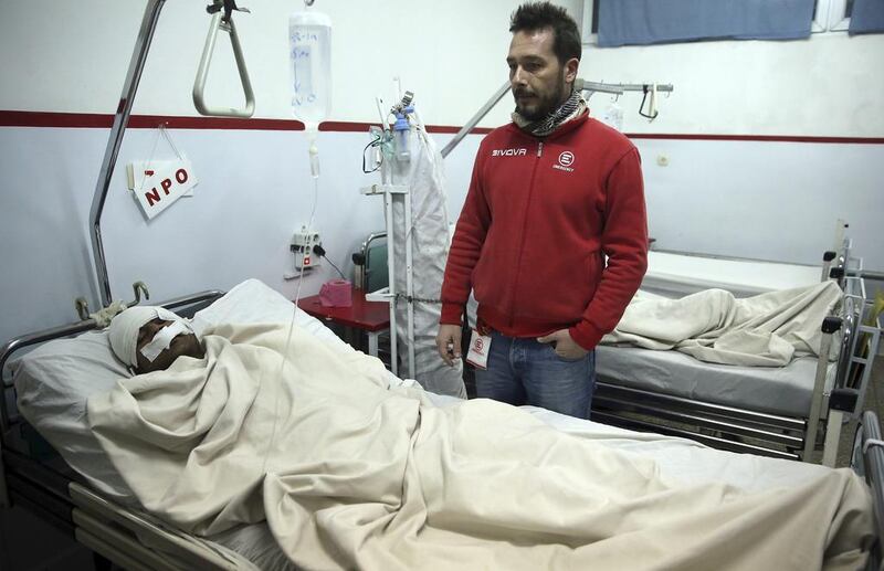 A man lies on a bed at a hospital after a suicide attack at the French Cultural Centre in Kabul on December 11, 2014 that killed a German citizen. Massoud Hossaini / AP Photo