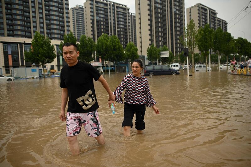 Walking hand-in-hand in search of refuge from the flood.