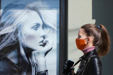 A woman walks near an advertising poster in Kiev, Ukraine. Speak your customers’ language, be relevant and give back to the community, says Manar Al Hinai. Reuters