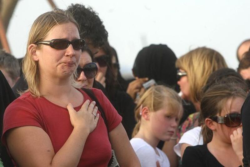 A woman reacts during a memorial held at the "Aspire Zone" close to the scene where two-year-old New Zealand triplets perished in a massive fire that tore through a nursery at a Qatar shopping mall  in Doha on May 29, 2012. Qatar started burying or repatriating the 19 victims of a massive fire that tore through a nursery at Vellagio mall, as investigators scoured for clues to the cause of the blaze that killed 13 children, including the New Zealand triplets. AFP PHOTO/STR


