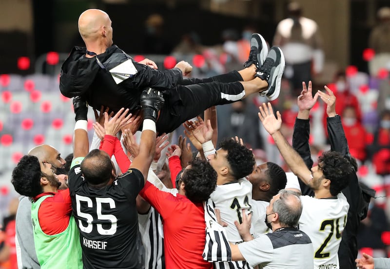 Players hoist Al Jazira manager Marcel Keizer during celebrations.