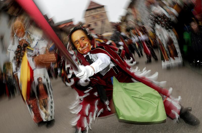 Carnival revellers in traditional costumes take part in the fool jump parade in Rottweil, Germany. Reuters