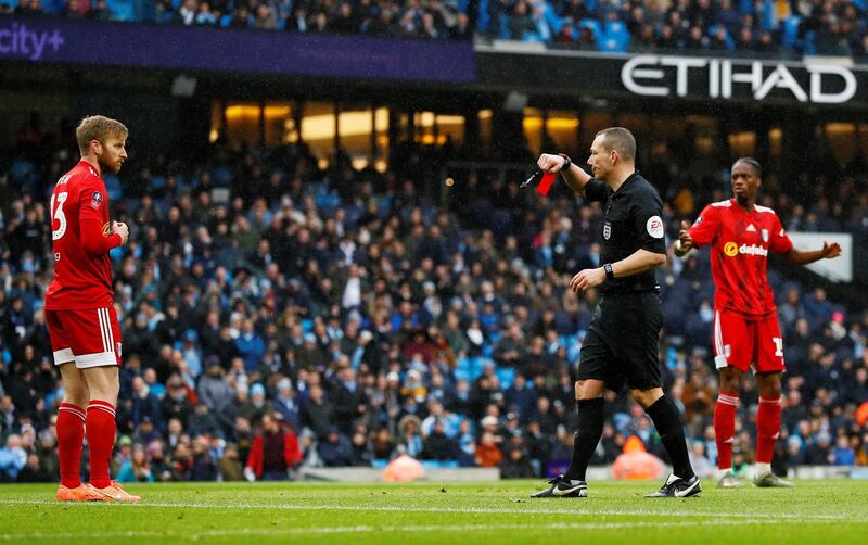 Fulham's Tim Ream is shown a red card by referee Kevin Friend. Reuters