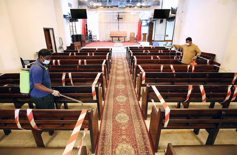 Workers sterilise the National Evangelical Church in Kuwait City.  AFP