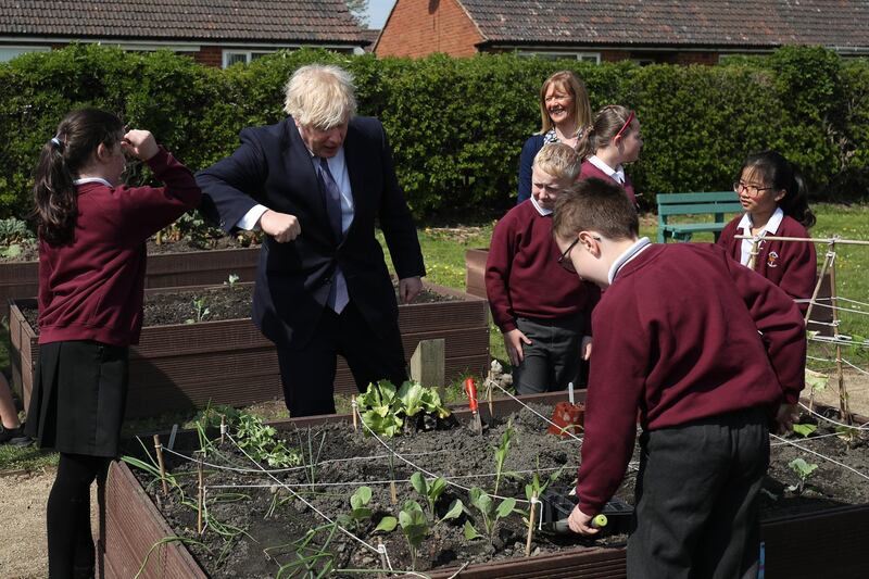 Boris Johnson elbow bumps a pupil during the visit. Getty Images