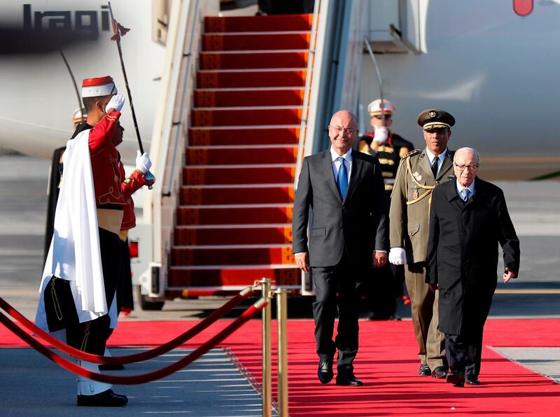 Tunisian President Beji Caid Essebsi, right, welcomes his Iraqi counterpart Barham Salih upon his arrival at Tunis-Carthage international airport. AFP
