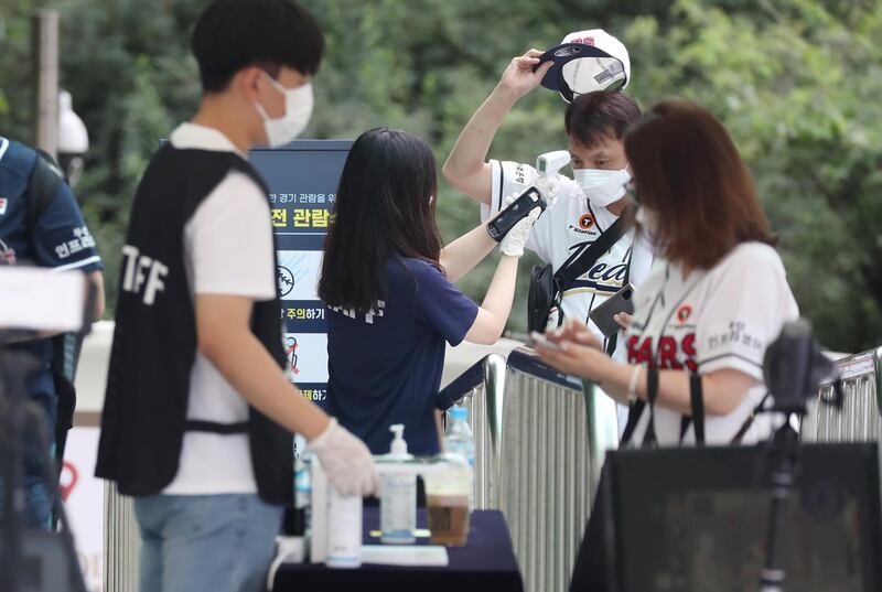 A fan has his temperature checked before entering Jamsil Baseball Stadium for the match between the Doosan Bears and the LG Twins. EPA