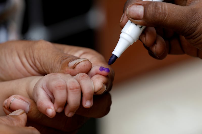 A boy gets his finger marked after he is administered polio vaccine drops in Karachi. Reuters