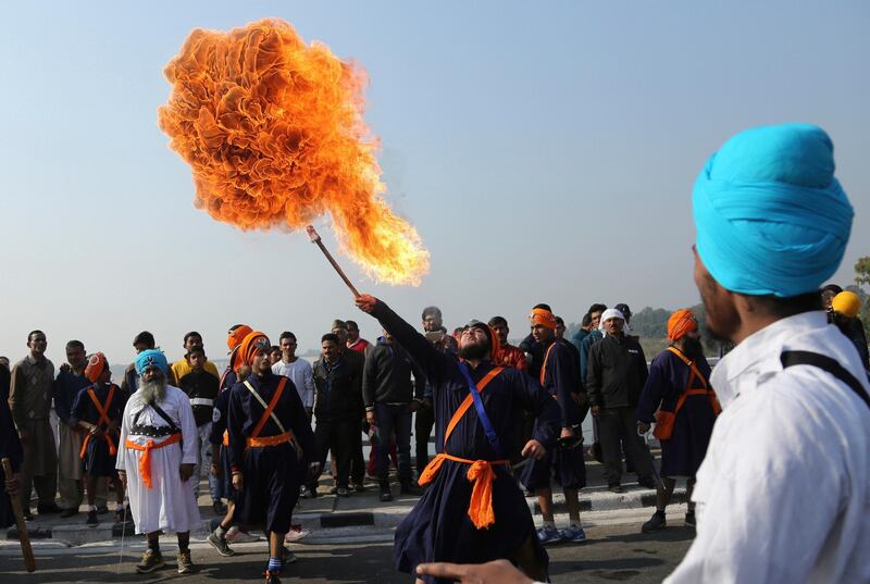 An Indian Sikh warrior performs a fire act during a religious procession ahead of the birth anniversary of Guru Gobind Singh in Jammu, India. Channi Anand / AP Photo