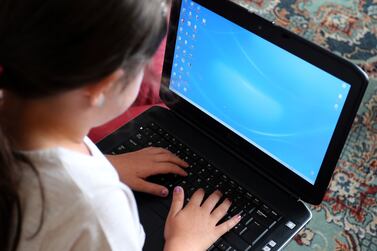 File photo dated 21/08/14 of a child using a laptop computer, as some pupils have begun the new school term learning remotely as the Omicron variant causes disruption across the country.