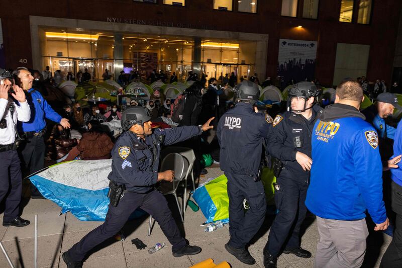 Police officers disperse pro-Palestinian students and protesters who set up an encampment on the campus of New York University. AFP