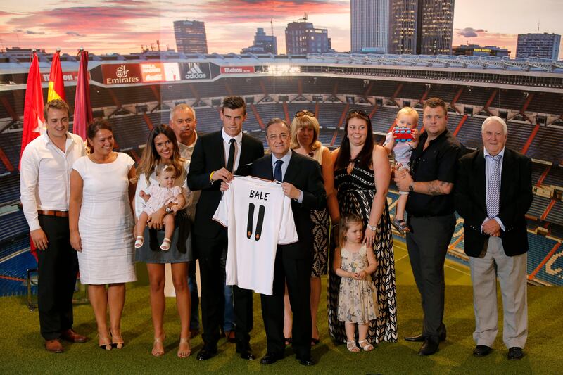 Welsh international soccer player Gareth Bale, his relatives, and Real Madrid President Florentino Perez pose during his official presentation at the Santiago Bernabeu stadium  in Madrid, Spain, Monday, Sept. 2, 2013 after signing for Real Madrid. The Spanish club announced Sunday that Bale has signed a six-year contract, and a person familiar with the deal said the fee was a world-record euro100 million ($132 million).  (AP Photo/Daniel Ochoa de Olza) *** Local Caption ***  Spain Soccer Real Madrid Bale.JPEG-0c4bb.jpg