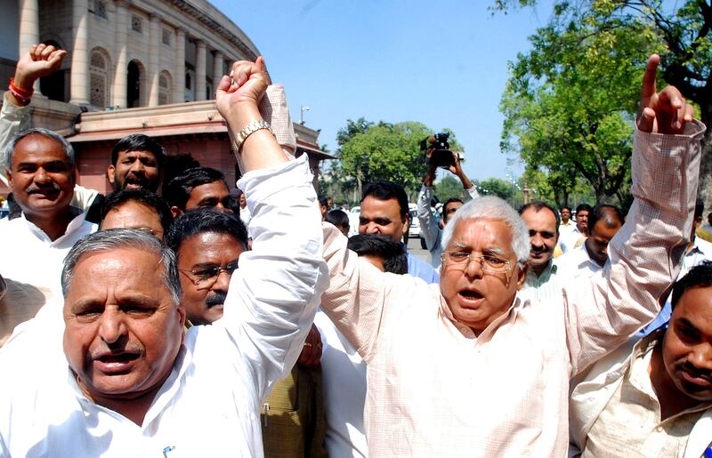 Yadav, left, holds hands with Rashtriya Janata Dal president Lalu Prasad Yadav during a protest against the proposed Women's Reservation Bill outside parliament in New Delhi in March 2010. EPA