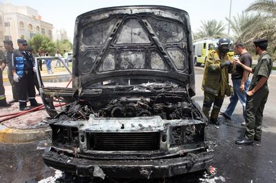 May 19, 2010 / Abu Dhabi / Firefighters put out a car fire after 2001 Range Rover burst into flames on 21st Street in Abu Dhabi May 19, 2010.  Luckly the driver and his son escaped the vehicle unharmed. (Sammy Dallal / The National)