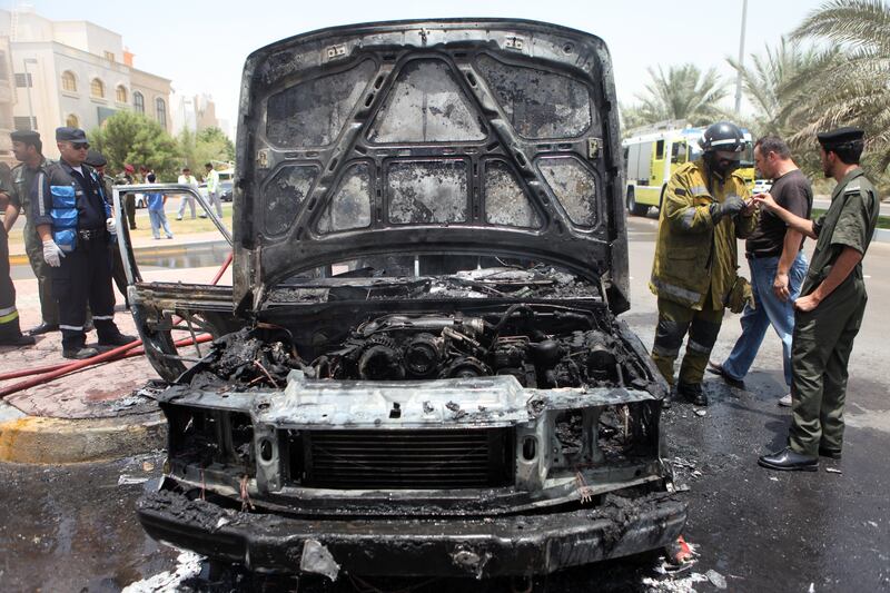 May 19, 2010 / Abu Dhabi / Firefighters put out a car fire after 2001 Range Rover burst into flames on 21st Street in Abu Dhabi May 19, 2010.  Luckly the driver and his son escaped the vehicle unharmed. (Sammy Dallal / The National)