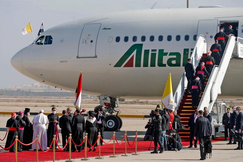 Cardinals and ranking Catholic clergymen board the Alitalia Airbus A330 aircraft as Pope Francis bids farewell to other bishops and Iraq's President Barham Saleh and his wife Sarbagh before departing from the Iraqi capital's Baghdad International. AFP
