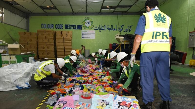 Dubai Customs officials pictured with counterfeit goods that were seized in September 2020. Courtesy: Dubai Customs