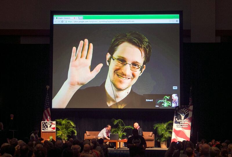 FILE - In this Feb. 14, 2015, file photo, Edward Snowden appears on a live video feed broadcast from Moscow at an event sponsored by ACLU Hawaii in Honolulu. Snowden has written a memoir, telling his life story in detail for the first time and explaining why he chose to risk his freedom to become perhaps the most famous whistleblower of all time. (AP Photo/Marco Garcia, File)