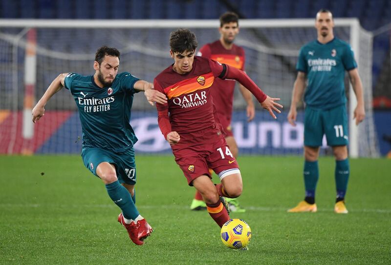 Roma's Gonzalo Villar in action with AC Milan's Hakan Calhanoglu. Reuters