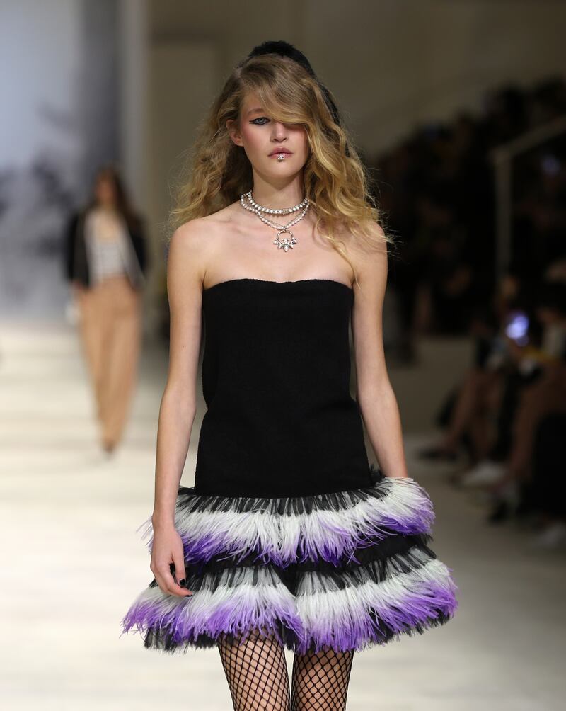 A sassy little black dress is fringed with feathers