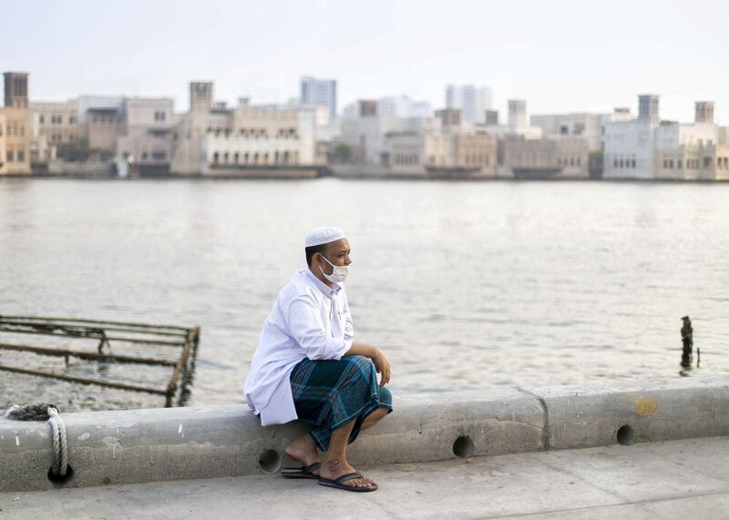 DUBAI, UNITED ARAB EMIRATES. 4 JUNE 2020. A man sits by Dubai Creek on Baniyas road in Deira.(Photo: Reem Mohammed/The National)Reporter:Section: