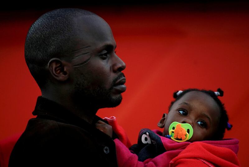 A migrant and his child, part of a group intercepted off the coast in the Mediterranean, stands in a queue after arriving on a rescue boat at the port of Motril, southern Spain. Juan Medina/Reuters