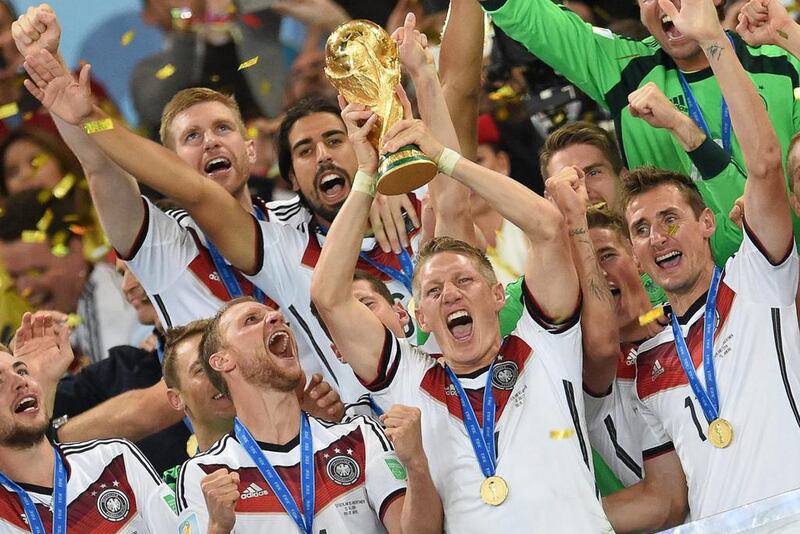 Bastian Schweinsteiger lifts the World Cup trophy after helping Germany defeat Argentina in the 2010 final in Brazil. Andreas Gerbert / EPA