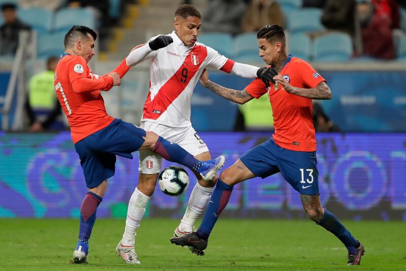 Peru's Paolo Guerrero, center, vies for the ball with Chile's Gary Medel, left, and Chile's Erick Pulgar, right, during a Copa America semifinal soccer match at the Arena do Gremio in Porto Alegre, Brazil. Peru defeated Chile 3-0 and qualified to the final. AP